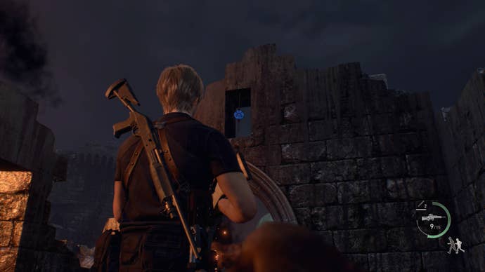 Leon Kennedy raising his pistol to shoot a blue medallion in the Castle Gate area of Resident Evil 4
