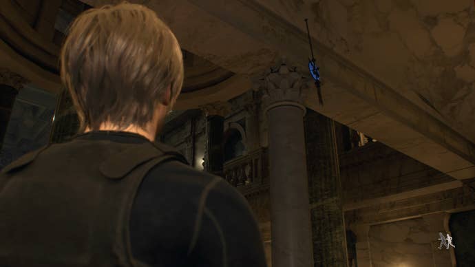 Leon Kennedy standing next to a blue medallion behind the unfinished statue in the Great Hall in Resident Evil 4