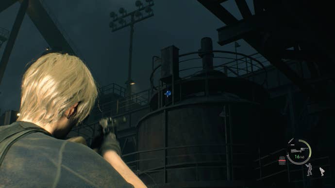 Leon Kennedy aiming a gun at a blue medallion on the side of a tank in the Cargo Depot in Resident Evil 4