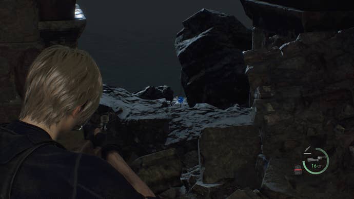 Leon Kennedy aiming at a blue medallion off the side of the path in the Cliffside Ruins in Resident Evil 4