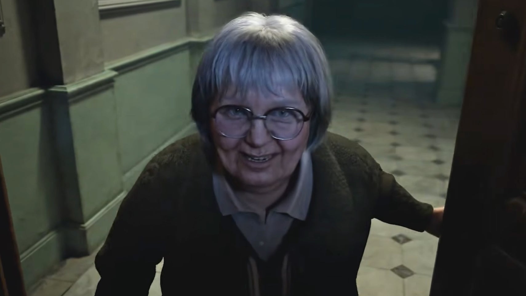 Resident Evil Veronica trailer image showing a first-person view of an elderly woman as she answers the door to Claire Redfield.
