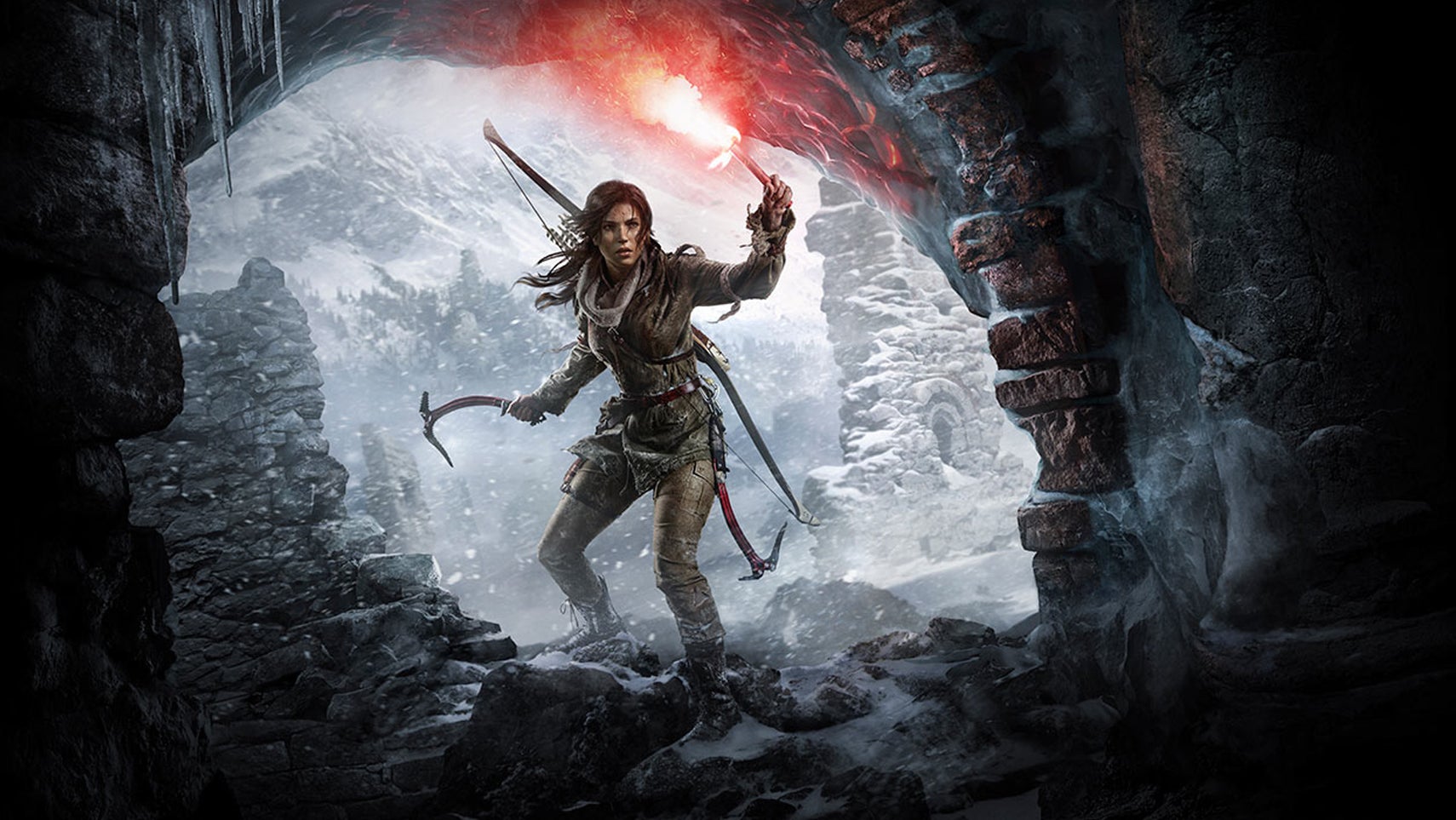 Lara Croft is stood at the entrance of a cave, it's snowing heavily outside, she has a flare in her hand in key art for Rise of the Tomb Raider. - 1