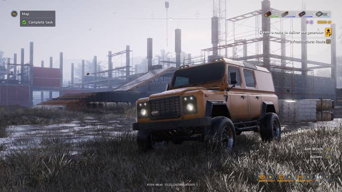A yellowish cross-country motortruck passes by a operation yard.