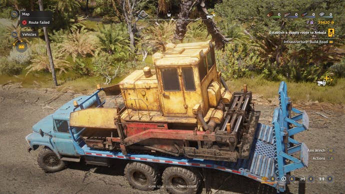 A conveyance transporter hauls an asphalter crossed a dusty roadworthy successful Africa.