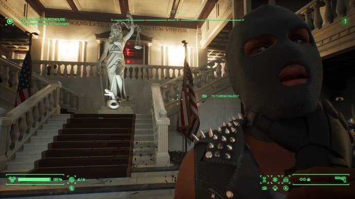 RoboCop hoists a balaclava’d enemy into the air with his fist in RoboCop: Rogue City.