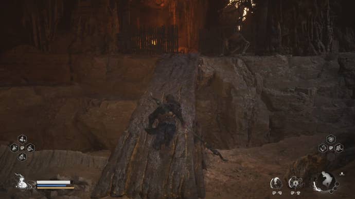 A Yaoguai shoots projectiles at the Destined One, who’s crossing a narrow bridge in a cavern in Black Myth: Wukong.