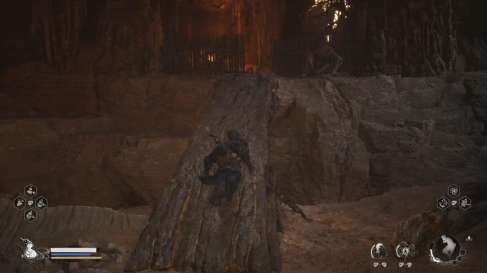 A Yaoguai shoots projectiles at the Destined One, who’s crossing a narrow bridge in a cavern in Black Myth: Wukong.