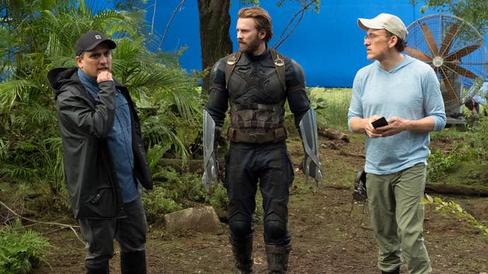 Joe and Anthony Russo stood with Chris Evans on the set for an Avengers moving, they’re talking about something.