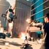 The player fires uzis at a helicopter while all-round chaos ensues in Saints Row.