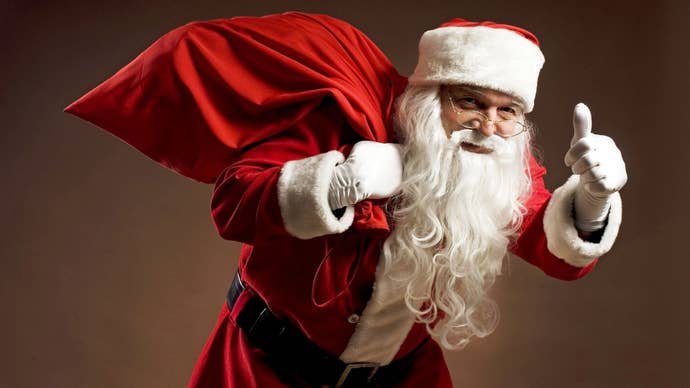 Santa Claus gives a thumbs up as he holds his sack over his back