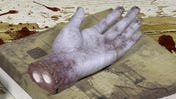 Saw board game takes Kickstarter miniatures to a grim new level with a life-sized severed hand