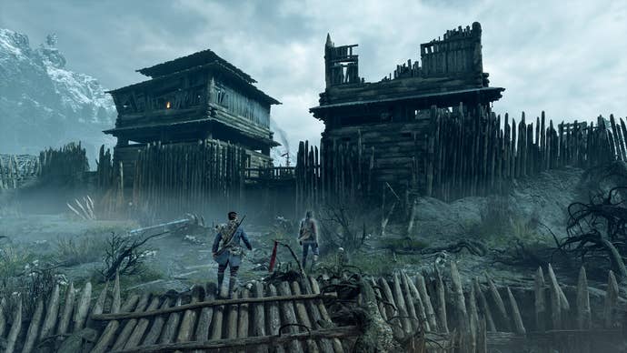 A ruined, overcast town entrance with a fallen stake fence in Banishers: Ghosts of New Eden