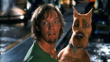 Shaggy and Scooby in the 2002 Scooby-Doo movie looking scared while stood on a street at night.