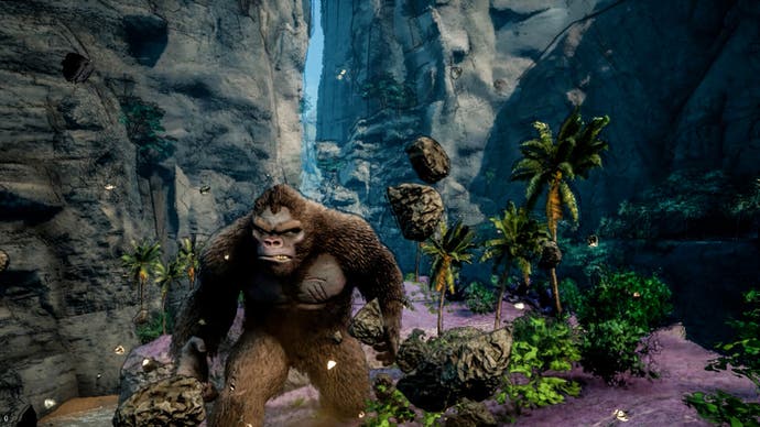 King Kong in Skull Island: Rise of Kong frowning at the camera. A number of rocks are falling to the ground near him. He is surrounded by sparse trees and rocky canyons