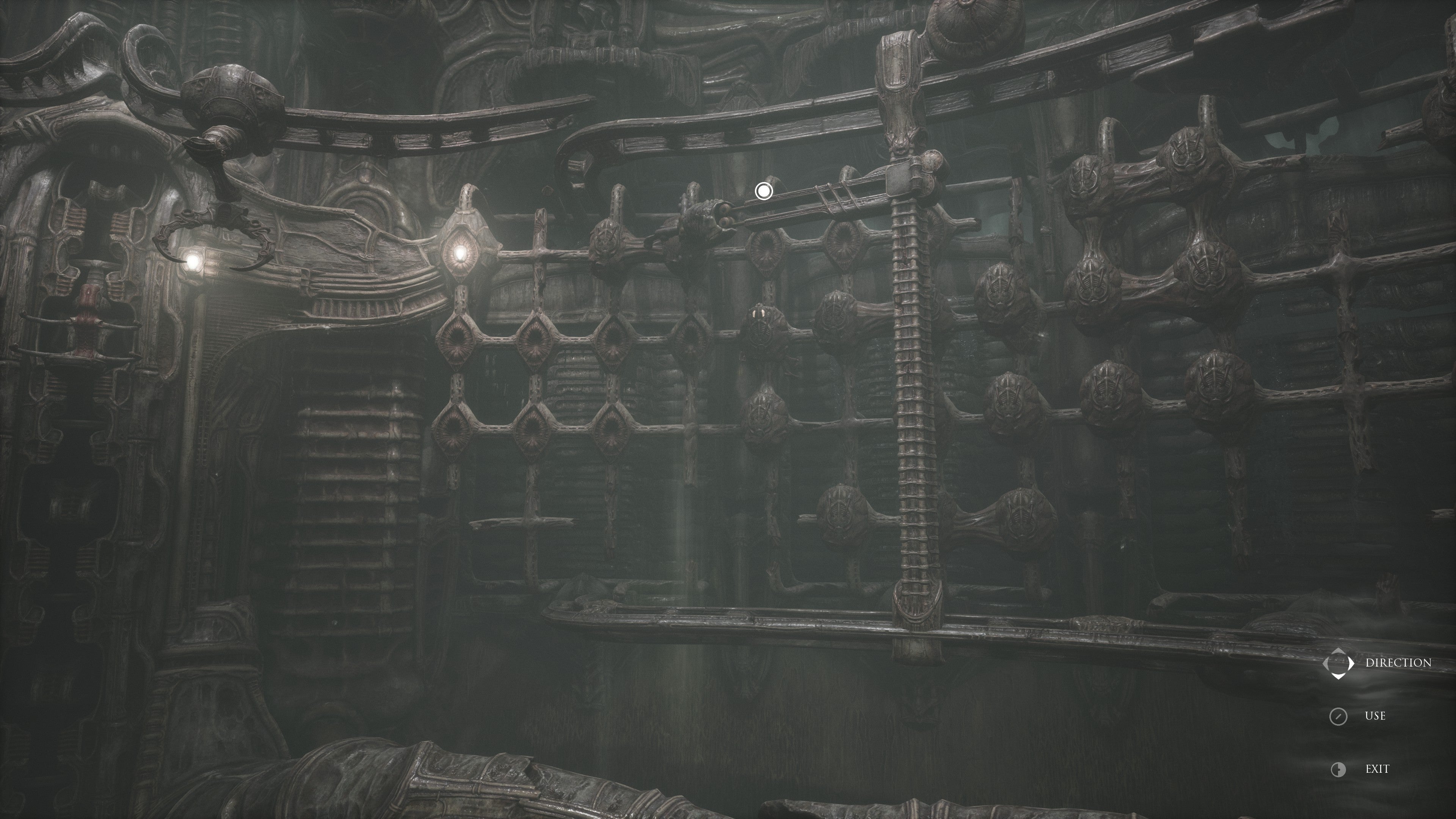 Scorn review - a dimly lit room with spherical skull-like objects on the walls