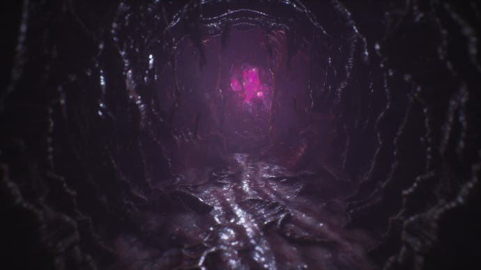 Scorn review - a black, organic-looking corridoor with something glowing an ominous purple at the end