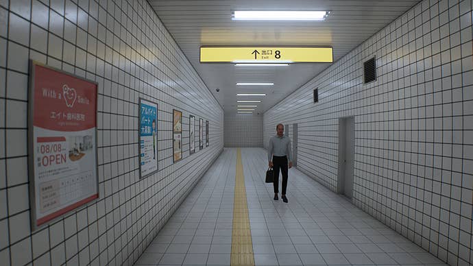 The player character walks through a train station platform in The Exit 8