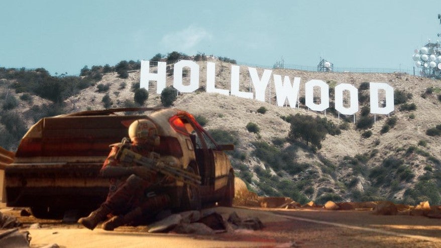 screenshot from arc raiders showing a chap hiding behind a car overlaid on an image of the Hollywood sign