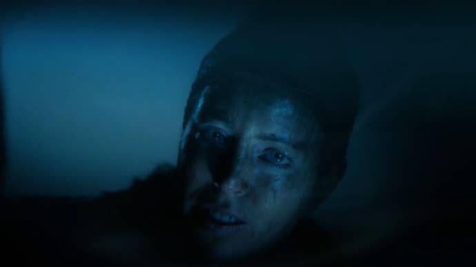 Senua looking at her reflection in a pool in a trailer for Senua’s Saga: Hellblade II