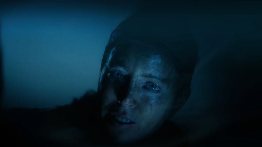 Senua looking at her reflection in a pool in a trailer for Senua’s Saga: Hellblade II