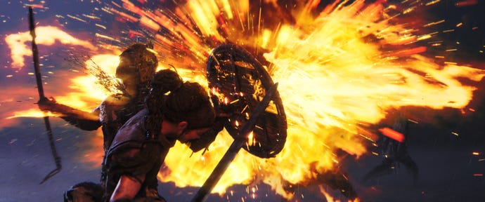 Senua holds her shield up protectively against a burst of flame in Senua's Saga: Hellblade 2.