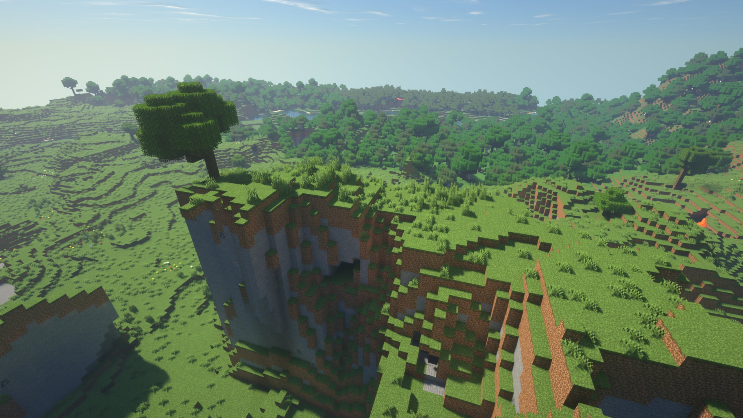 A Minecraft cliff, with a tree on the very edge of the cliff with SEUS Renewed shaders installed.