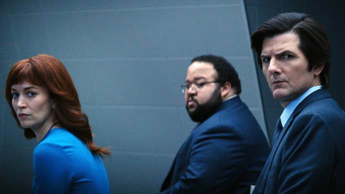 A photo from the TV show Severance, showing the smartly office-attired characters Helly, Dillon and Mark S, as they turn to the camera with quizzical expressions on their faces.