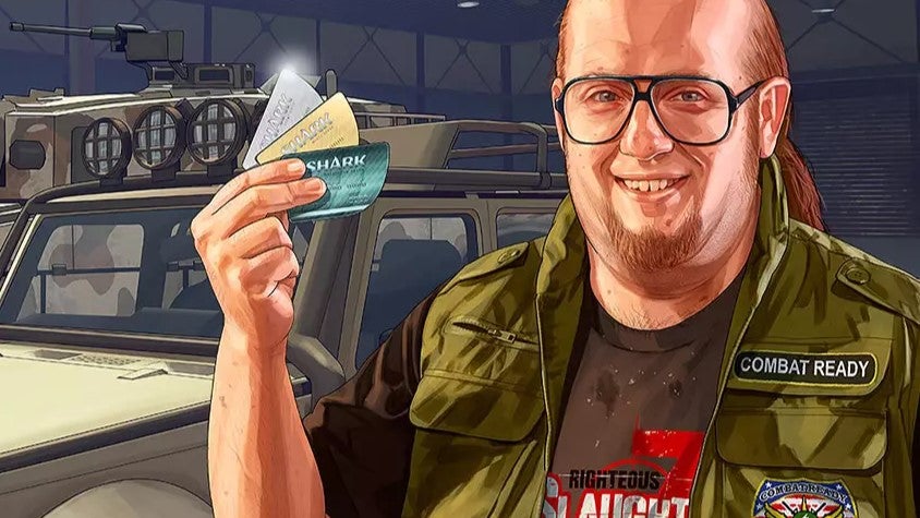 A character from Grand Theft Auto 5 brandishing a handful of GTA Online Shark Cash Cards - 1