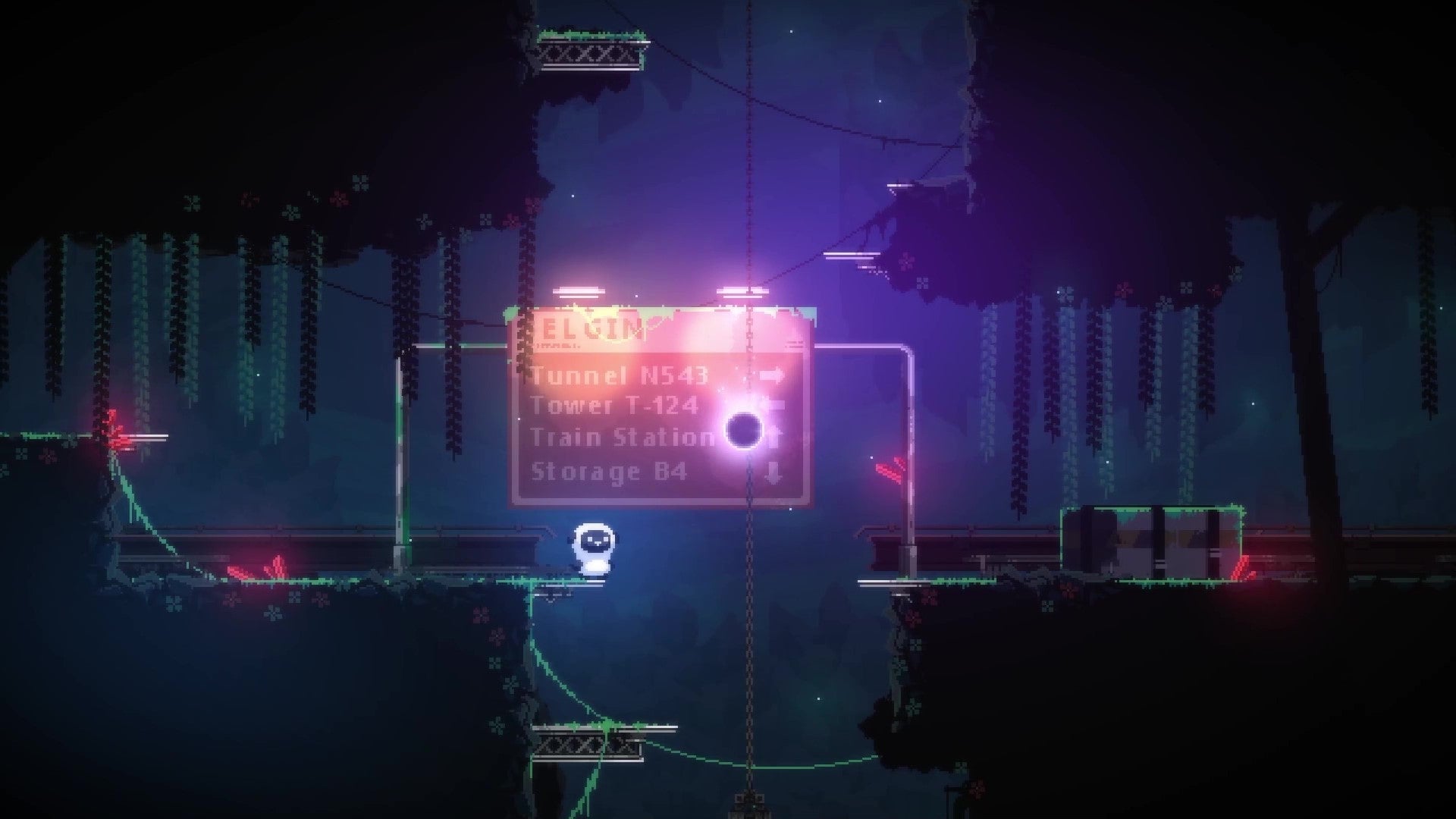 A plush sheep stands on the edge of a gap in the floor an industrial-style underground room. An illuminated street sign provides a backdrop as well as one of the few spots of colour. - 33