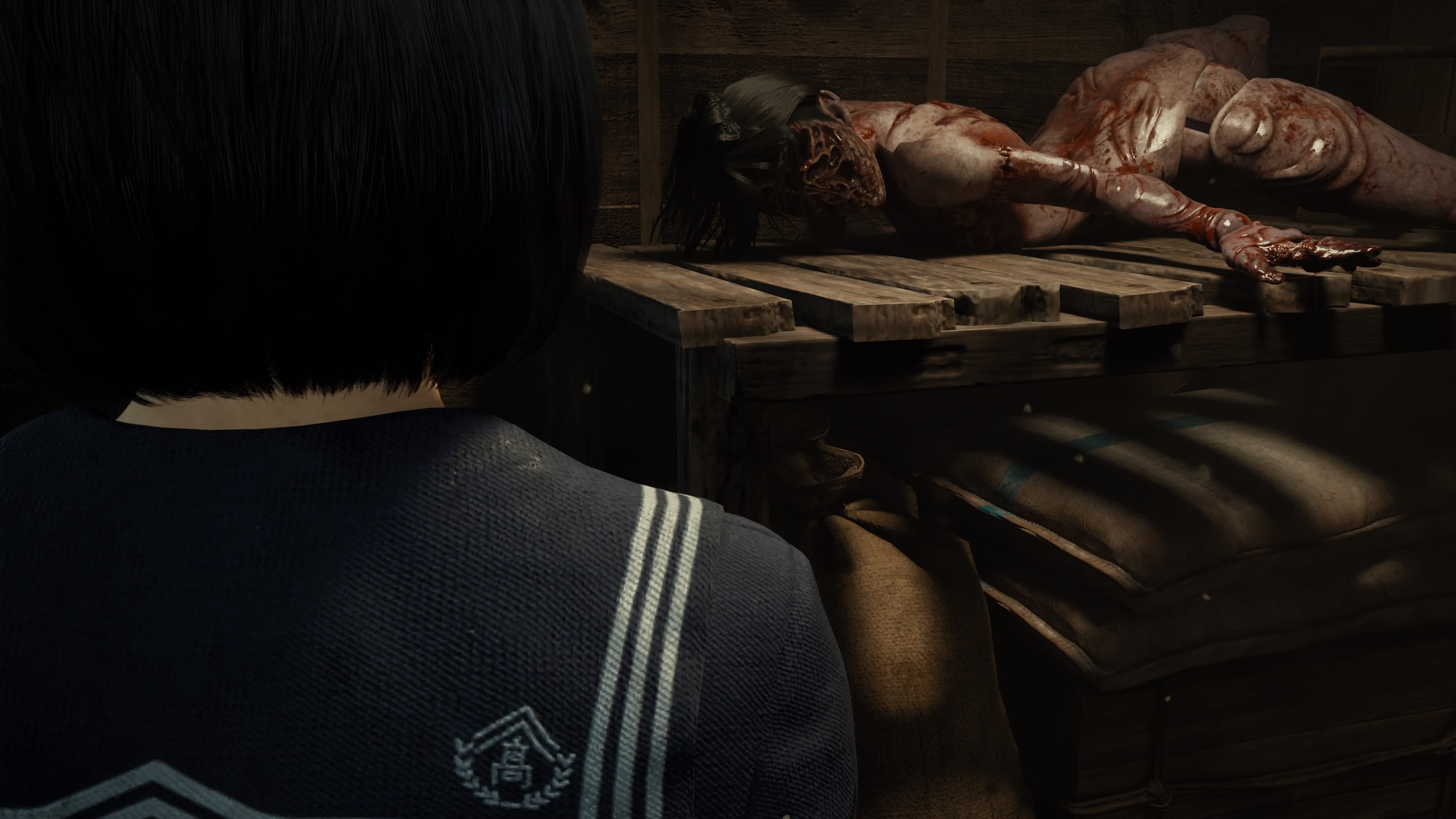 Over Hinako's shoulder, we can see a close-up of an enemy. Naked and covered in blood, its face is missing, as though perhaps ripped off.