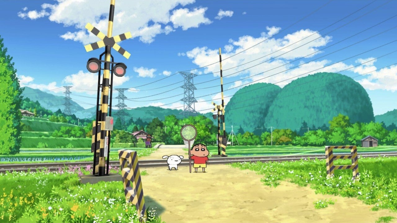 Shin chan and Shiro stand on a country path next to a railway line, as Shin chan holds a bug net and the sky is lovely and blue. - 1
