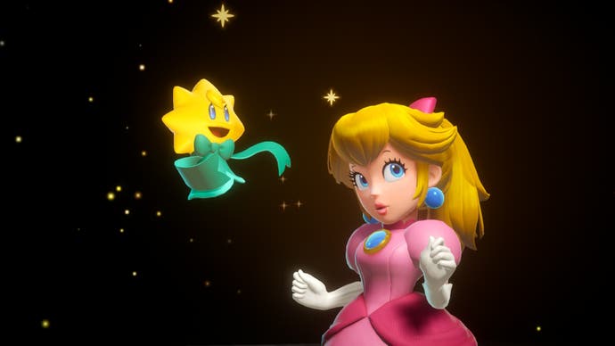 Three: Princess Peach: Showtime! screenshot shows Stella and Peach posing in a dark room, surrounded by sparkles.