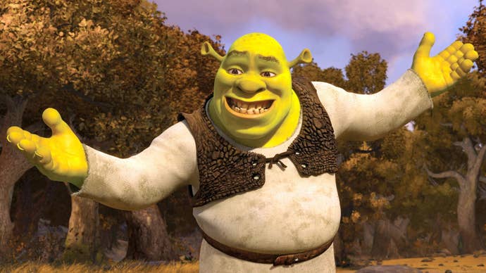 Shrek holding out his arms while awkwardly smiling in the middle of the woods at sunset.