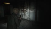 Silent Hill 2 remake screenshot of James holding a pistol, looking at a dirty wall with text on it that reads "reap what you sow."