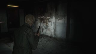 Silent Hill 2 remake screenshot of James holding a pistol, looking at a dirty wall with text on it that reads "reap what you sow."