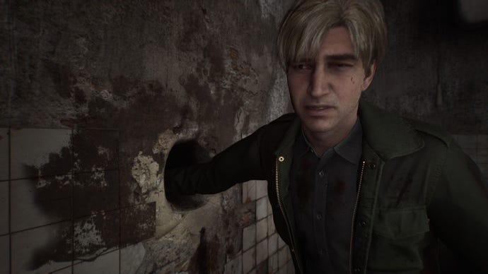 James sticks his arm down a hole to look for an item.