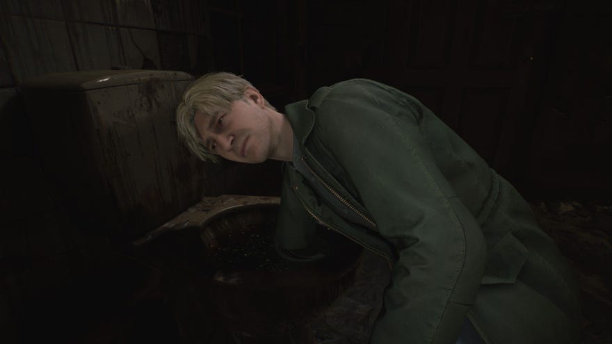 James sticks his hand down a toilet in search of an item.
