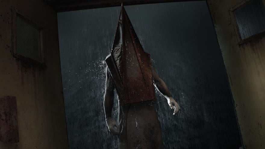 Pyramid Head steps into a hallway from the rain in the Silent Hill 2 remake