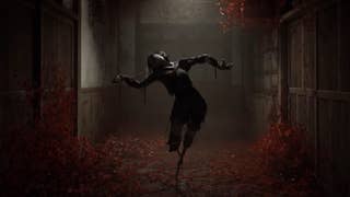 A scene from the Silent Hill f trailer showing a scarecrow-like figure resembling an awkwardly twisted Japanese school girl balanced on spindly limbs. It stands illuminated by a dim light in a hallway covered in blood-red blooms.
