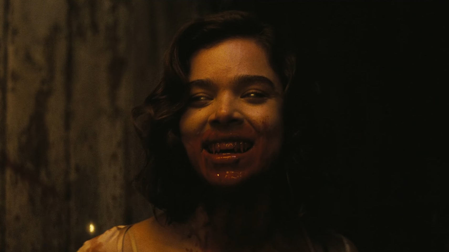 Hailee Steinfeld in Sinners, her mouth is covered in blood, she has sharp fangs and faintly glowing yellow eyes. - 1