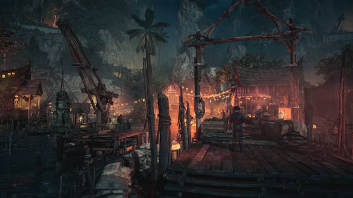 Skull and Bones screenshot showing a pirate town glowing orange in the night