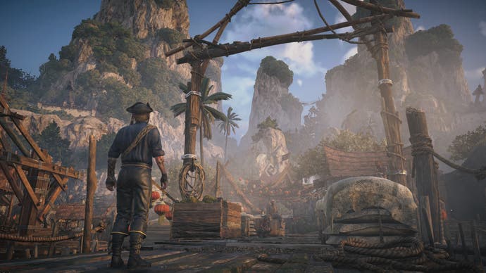 Skull and Bones screenshot showing a pirate at a port with tropical mountains in the distance