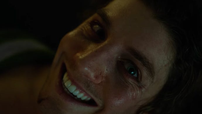 A close-up of a man smiling menacingly in Smile 2.