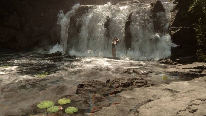 Sons of the Forest Virginia: A woman with three legs and three arms is standing under a short waterfall in the distance