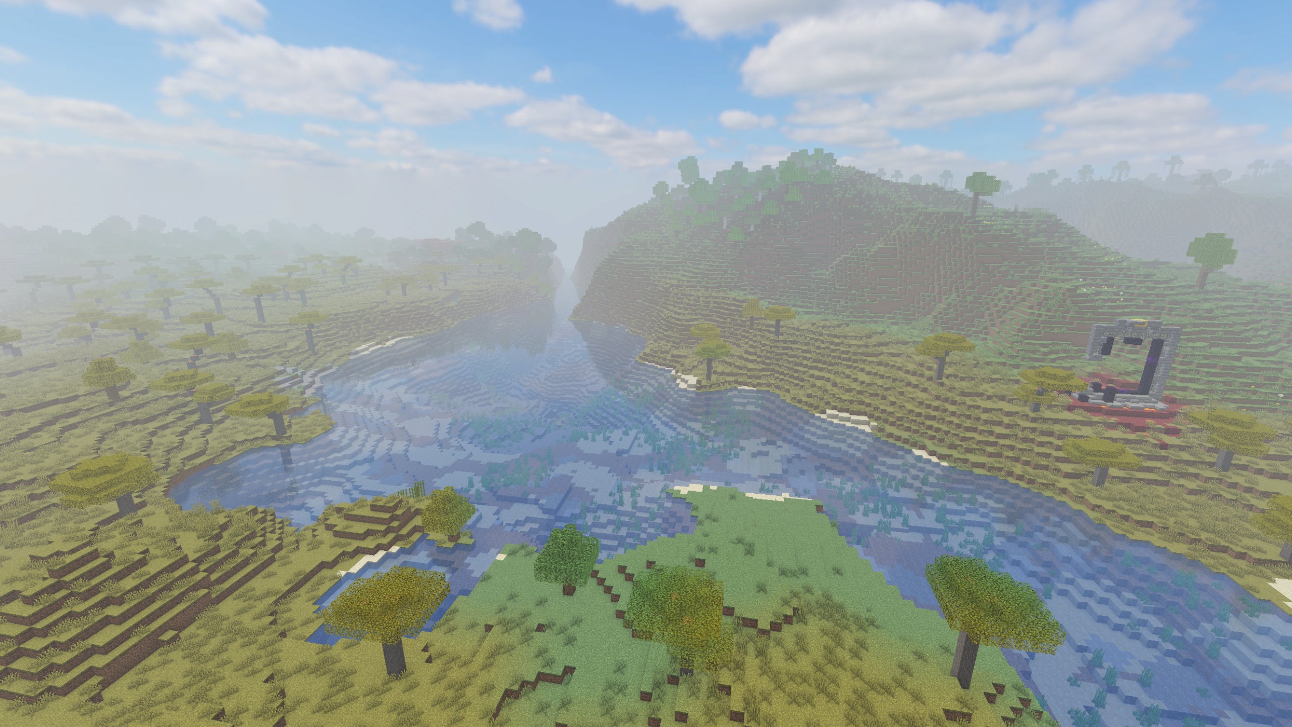 A river in a Minecraft landscape, with a ruined portal on the right-hand side with Sora Shaders installed.