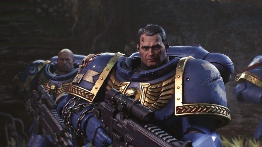 Titus the space marine looks toward the camera in his bulky blue armour.