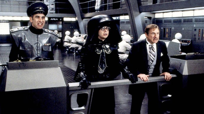 Still from Spaceballs showing Rick Moranis in a outfit parodying Darth Vader, he's wearing a similar helmet but it is massive, dwarfing his head.