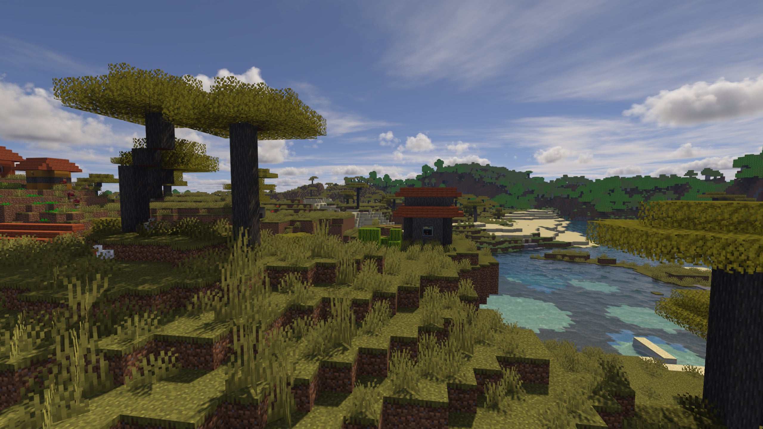 A savanna biome in Minecraft with Spectrum Shaders installed.