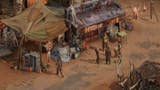 Broken Roads official screenshot showing a ramshackle desert town with several party members gathered in conversation