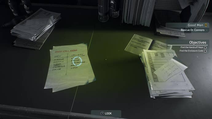 A desk piled with papers, including a list of Hunter callsigns.